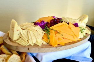 sliced cheese on brown wooden chopping board